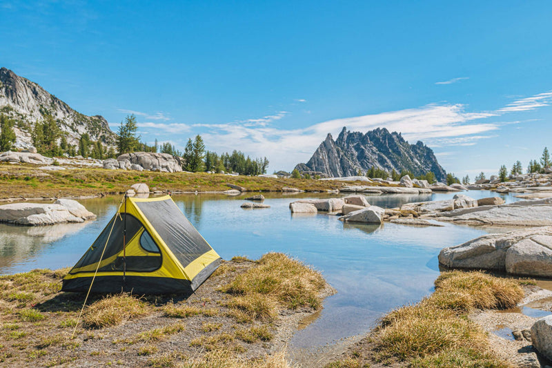 backpacking trekking pole tent outer shell set up near water