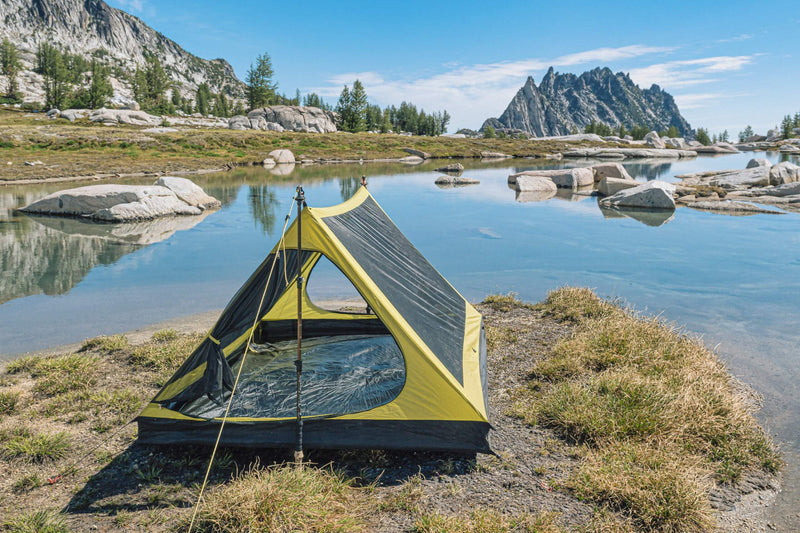 backpacking trekking pole tent set up near water